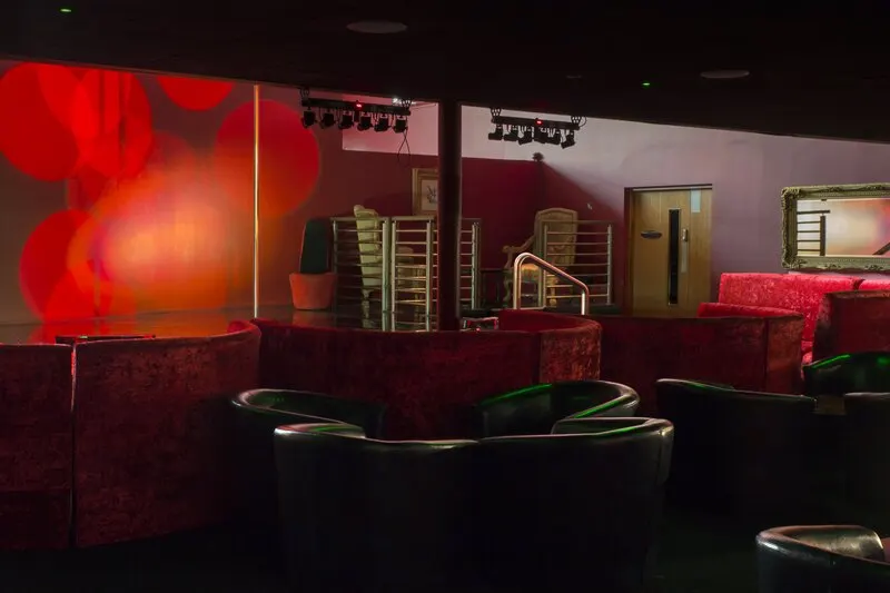 The Garudaa club floor with red velvet booths facing the stage