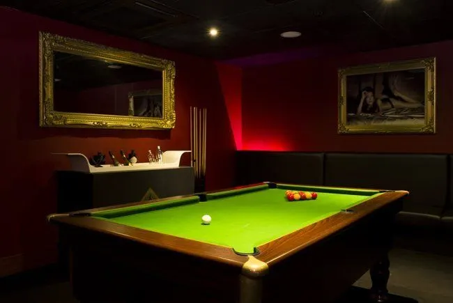 The games room with pool table and private seating